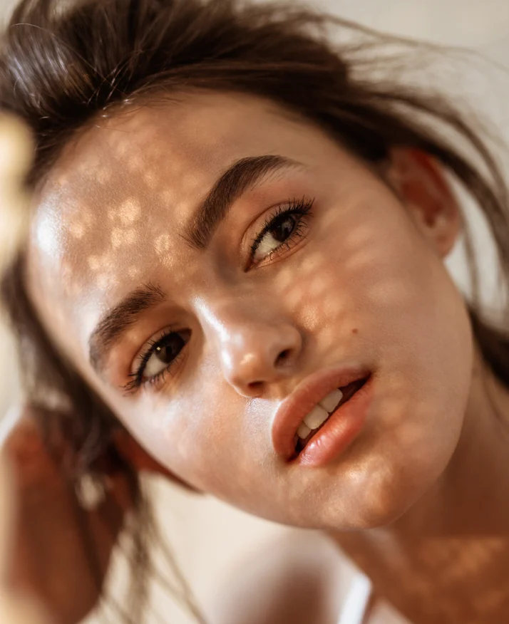Woman with her head tilted to the side looking off-screen - chemical peels